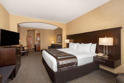 a hotel room with a large bed and a television at Wingate by Wyndham Moses Lake in Moses Lake