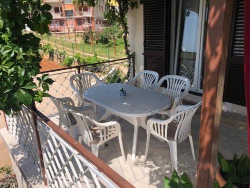 a blue table and chairs on a balcony at Villa Lorenta Apartments in Primošten