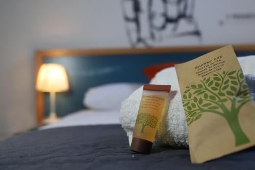 a bottle of sunscreen sitting on top of a bed at b&b Pirriera in Bagheria