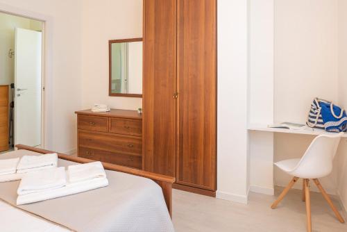 a bedroom with a bed and a dresser and a mirror at Bivio Family House By Case al Lago in Peschiera del Garda