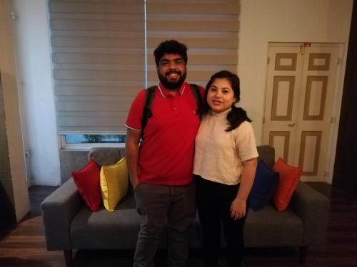 a man and a woman standing in front of a couch at Eden Studio Apartments - 1 in Colombo