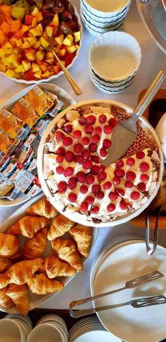 a table topped with a cake with fruit on it at San Teodoro in Korčula