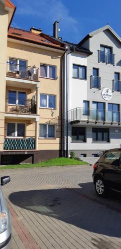 a car parked in front of a building at Apartament w Suwałkach in Suwałki