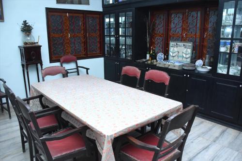 a dining room with a table and some chairs at Sharad Baug homestay in Bhuj