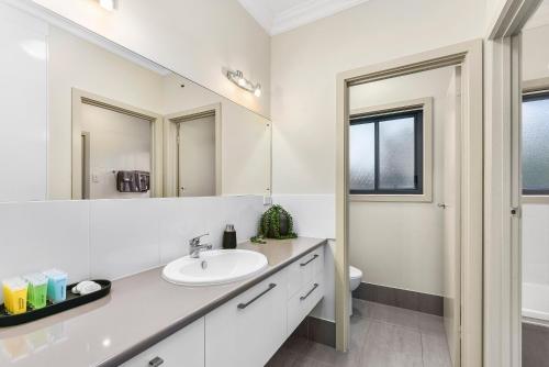 a white bathroom with a sink and a mirror at Accommodation on Lansell 2 in Mount Gambier