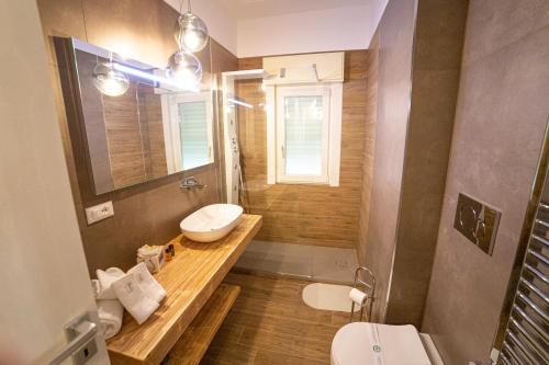 a bathroom with a sink and a toilet and a mirror at Chez Moi in Foggia