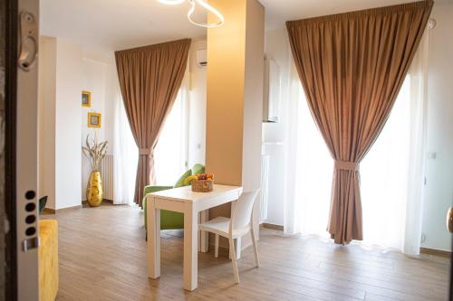 a dining room with a white table and chairs at Chez Moi in Foggia