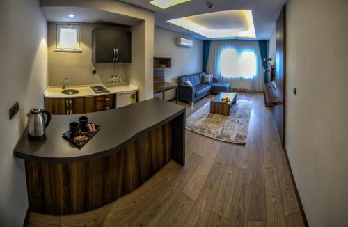 a kitchen and living room with a counter in a room at Ferah Suites Hotel in Trabzon