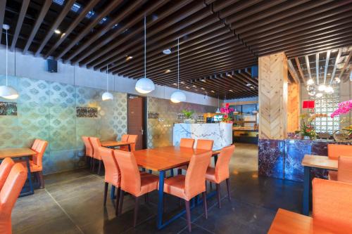 a dining room with a wooden table and orange chairs at 埔里夏都華蔓山林日式會館 Puli Huaman Villa in Puli