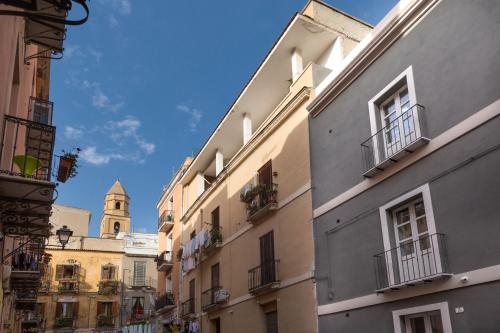 a city street with buildings and a clock tower at Cagliari Marina Harbour Guest house & Lounge in Cagliari