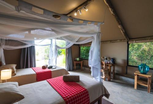 a bedroom with two beds in a tent at Caprivi Mutoya Lodge and Campsite in Katima Mulilo