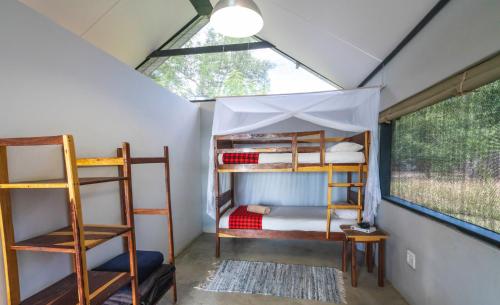 a room with bunk beds and a window at Caprivi Mutoya Lodge and Campsite in Katima Mulilo