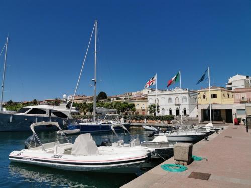 a group of boats are docked in a marina at Hotel Hieracon in Carloforte