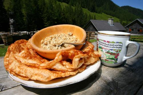a bowl of food on a plate next to a cup at Appartement Panorama in Gröbming