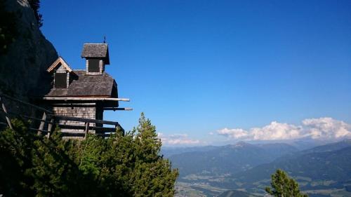 an old church on the side of a mountain at Appartement Panorama in Gröbming