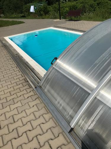 a swimming pool with a metal cover on a roof at Chata Eliška in Loučná nad Desnou