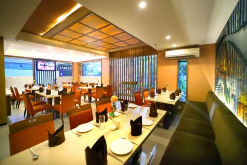 a restaurant with tables and chairs in a restaurant at Southern Plaza in Kolkata