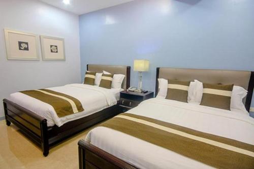 a hotel room with two beds in a room at Subic Bay View Diamond Hotel in Olongapo