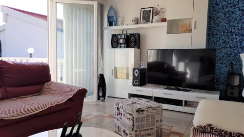 a living room with a large flat screen tv at Apartment Maslenica, near Zadar in Maslenica