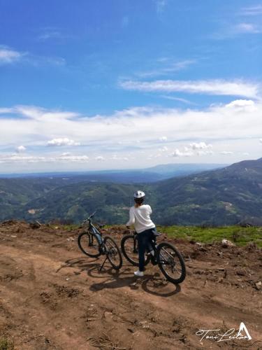 a person standing on a hill with two bikes at Casa Celeste in Castro Daire