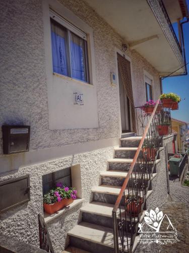 a set of stairs in front of a building with flowers at Casa Celeste in Castro Daire