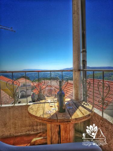 a table on a balcony with a view of the desert at Casa Celeste in Castro Daire