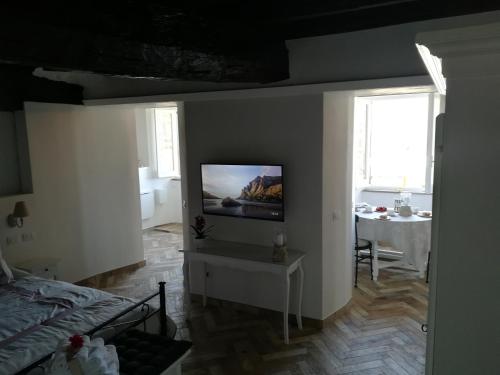 a living room with a television on a wall at Holiday Homes - mini spa - Nemi (Roma) in Nemi