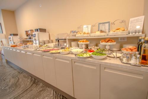 a buffet line with many plates of food on it at Ark Hotel in Verona