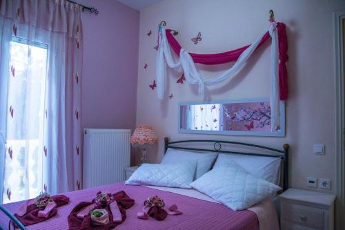 ラガナスにあるSweet Homeのベッドルーム1室(ピンクのシーツと天蓋付きのベッド1台付)