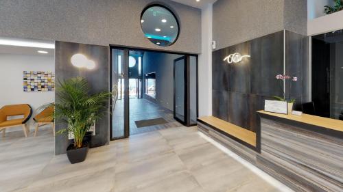 a lobby of an office with a mirror and plants at Medusa Apartments in Rethymno Town