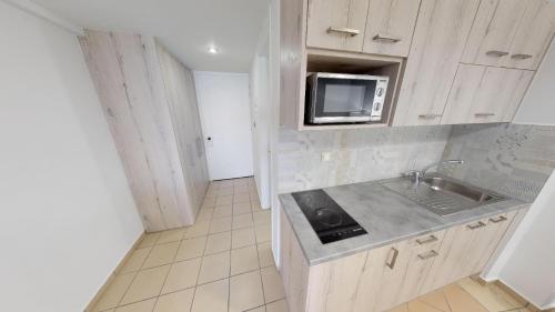 a kitchen with a sink and a microwave at Medusa Apartments in Rethymno Town