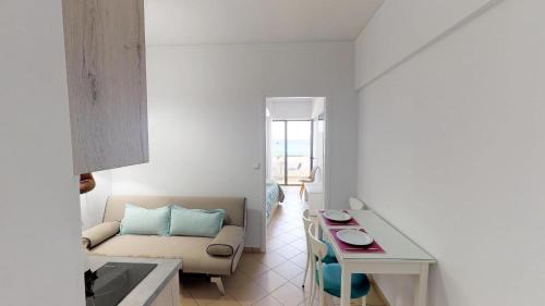 a living room with a couch and a table at Medusa Apartments in Rethymno Town