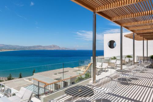 a view of the ocean from the balcony of a house at Lindos Mare, Seaside Hotel in Líndos