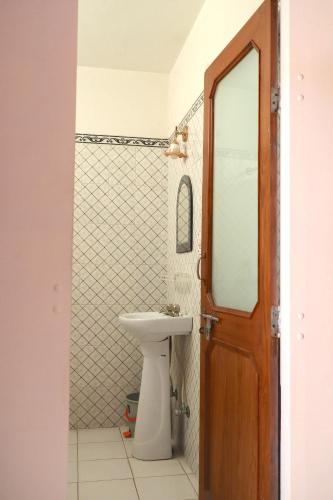 a bathroom with a sink and a mirror and a toilet at Shahar Palace in Jaipur