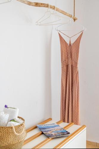 a dress hanging on a hanger on a table at Ornos Blue in Ornos
