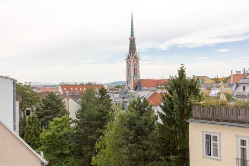 a view of a city with a church tower at RAFAEL KAISER - Premium Apartments - Contactless Check-In in Vienna
