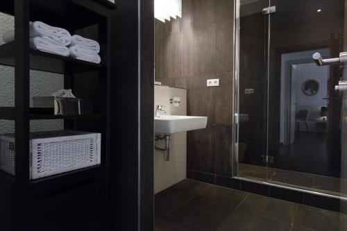 a bathroom with a sink and a glass shower at RAFAEL KAISER - Premium Apartments - Contactless Check-In in Vienna
