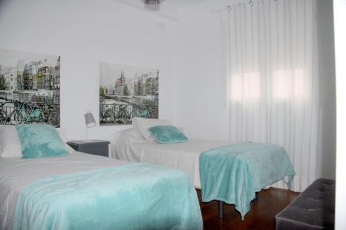 a hotel room with two beds and a window at Muro Center in Seville