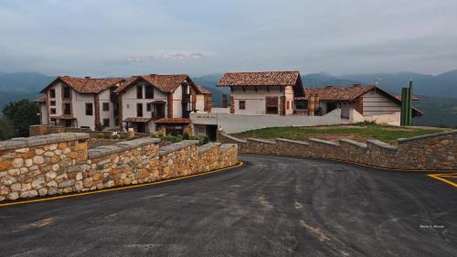 a road with a bunch of houses on a hill at Hotel Cerro La Nina in Beceña