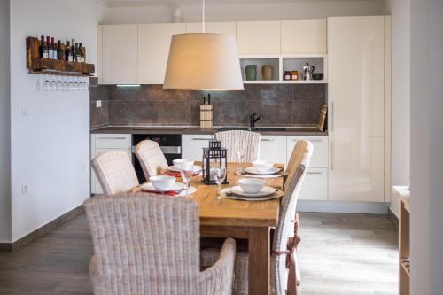 a kitchen with a wooden table and chairs at Villa Cavallo in Linardići