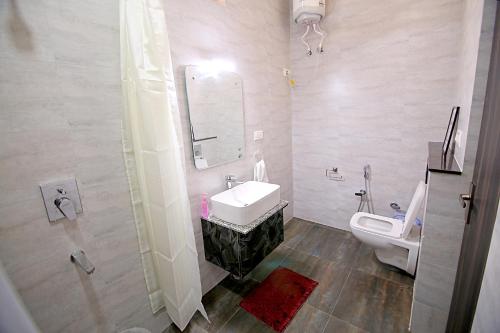 a bathroom with a sink and a toilet at The Hideout Agra - Garden Homestay near Taj in Agra