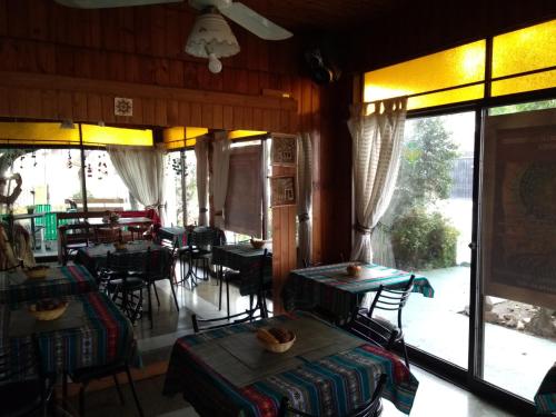 a restaurant with tables and chairs and a patio at Hotel La Marina in Villa Carlos Paz