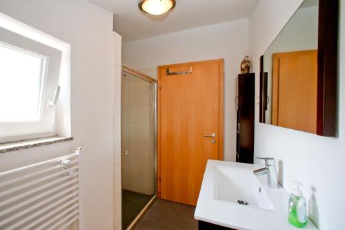 a bathroom with a sink and a mirror at BC Bikers Welcome Apartments in Senj