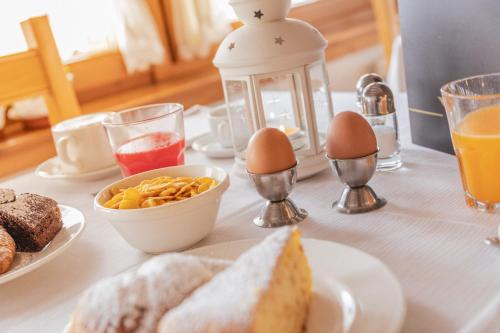 a table with eggs and bread and a lantern at Hotel Folgarida in Folgarida
