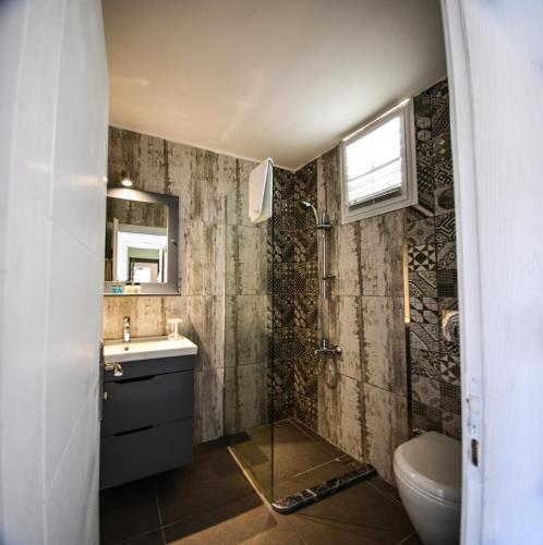 a bathroom with a sink and a toilet at Bedroom Alaçatı in Alaçatı