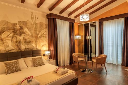 a bedroom with a bed and a glass table at Il Podere di Marfisa in Farnese