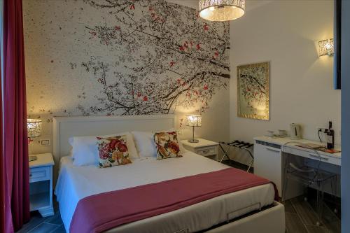 a bedroom with a bed and a wall with a painting at Il Podere di Marfisa in Farnese