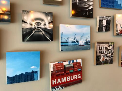a collage of photos of various items on a wall at Sandmann Boutique Hostel Hotel in Hamburg