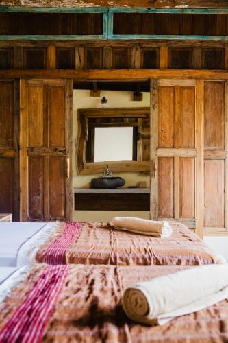 a bedroom with a bed and a sink in a room at Kalyssa Beach Bungalows in Pemuteran
