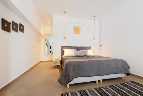 a bedroom with a large bed and a rug at Sigalas Beach Hotel in Kamari